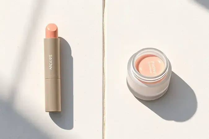 Render 3D comparando formatos de esfoliante labial em bastão e em pote com design minimalista.